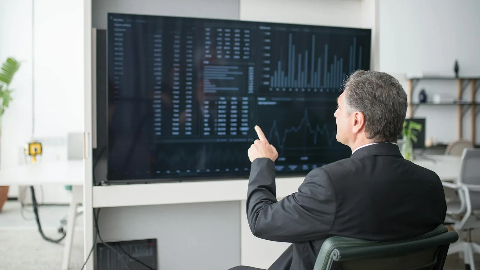 Sales dashboard displayed on a wall-mounted screen showing pipeline and quota data