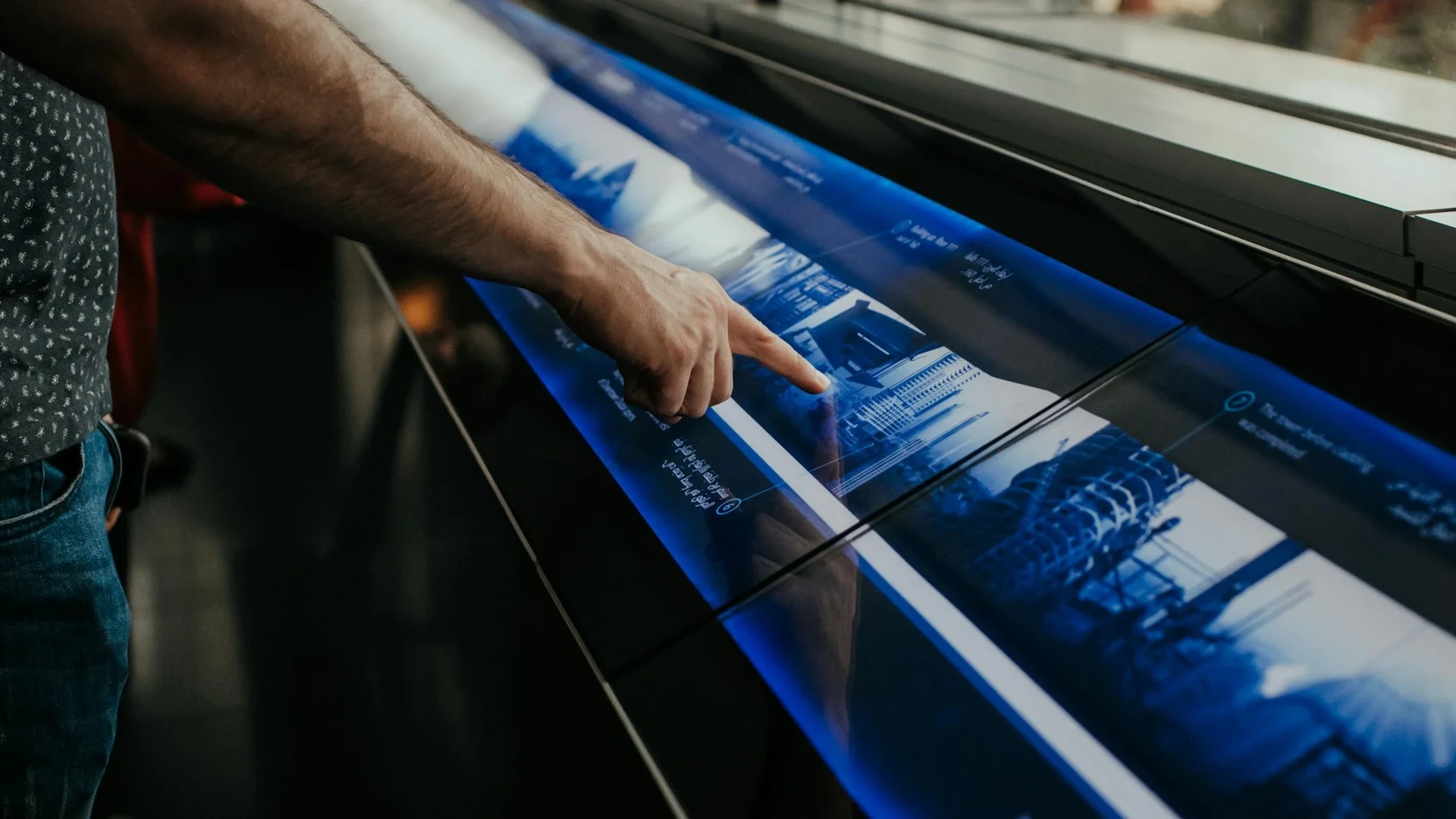 Person interacting with an IRL touch-screen exhibition display